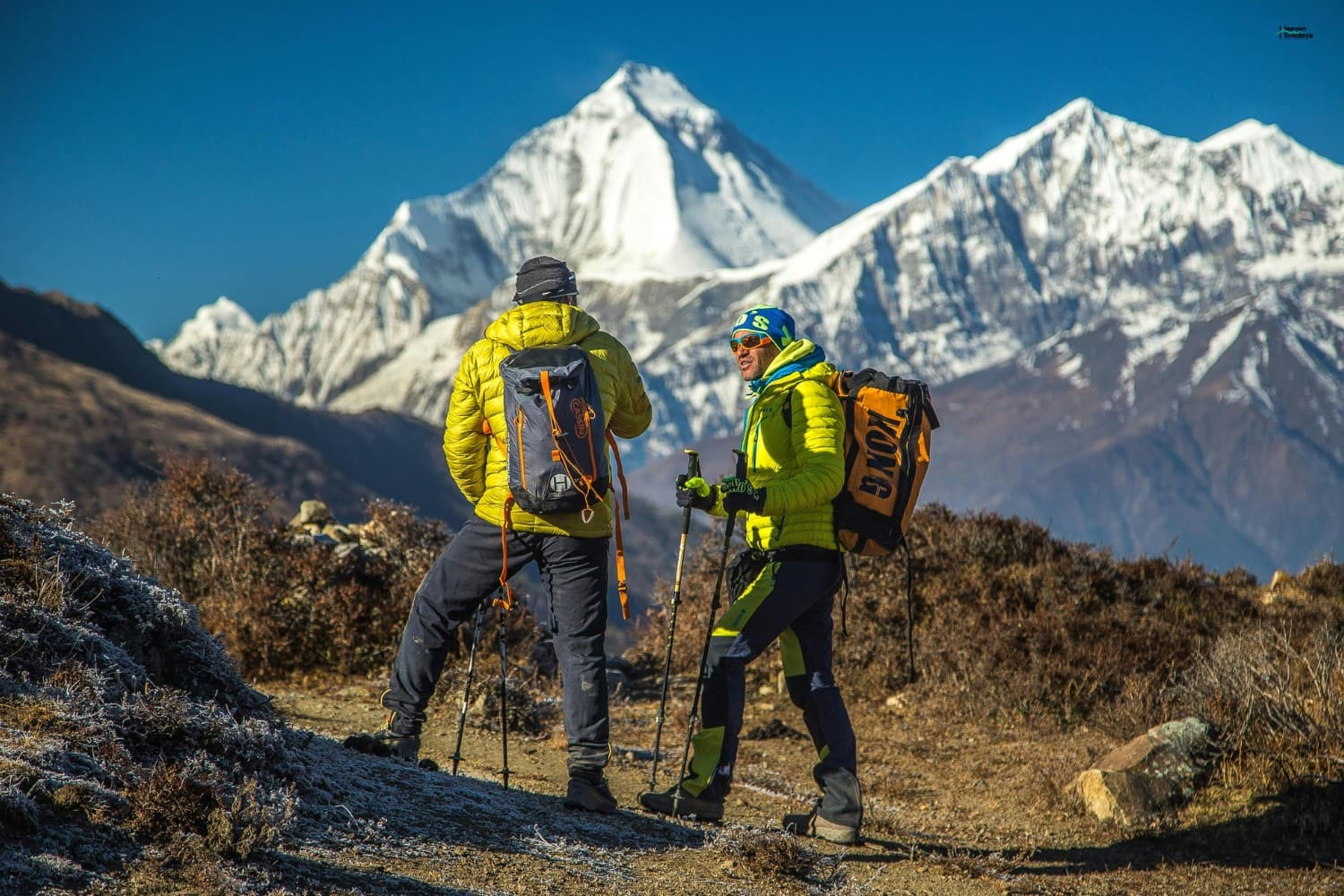 Two trekkers trekking in the Himalayas of Nepal