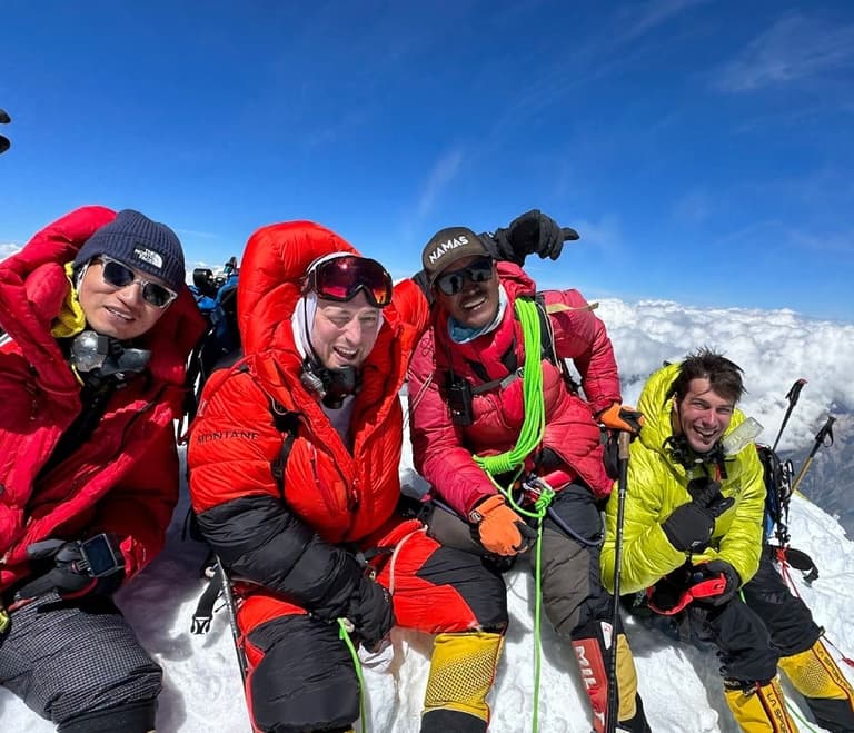 Climbers on top of mountain
