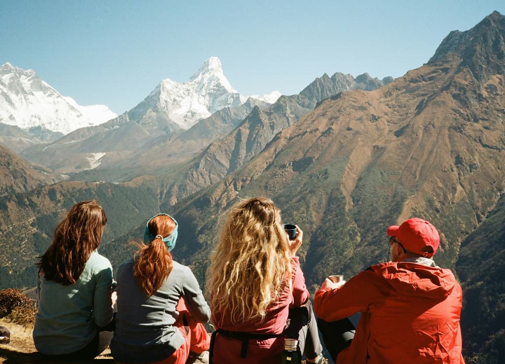 Trekkers enjoying the view while resting in Nepal.